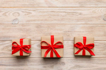 Valentine day composition: red gift box with bow and heart. Christmas present. View from above....