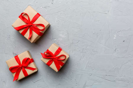 Valentine day composition: red gift box with bow and heart. Christmas present. View from above. Space for text. Holday greeting card.の写真素材