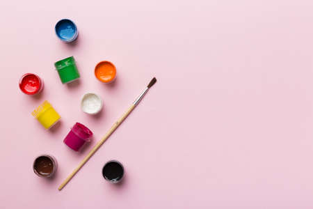 art palette with paint and brushes, close up. Top view with empty space. workplace for creativity. home teaching concept drawing.の写真素材