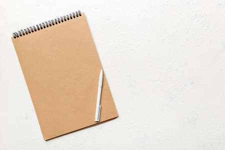 school brown notebook on a colored background, spiral craft notepad on a table Top view.