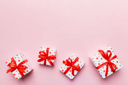 Valentine day composition: red gift box with bow and heart. Christmas present. View from above....