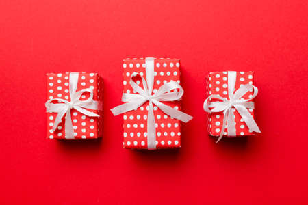 Valentine day composition Background: red gift box with bow and heart. Christmas present. View from above. Holday greeting card.の写真素材