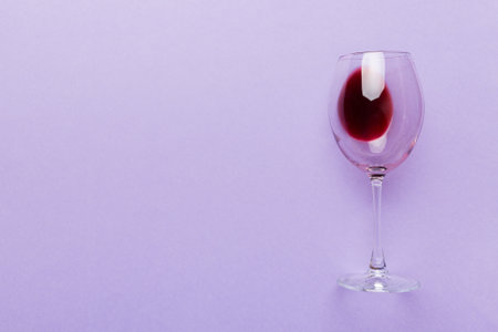 One glasses of red wine at wine tasting. Concept of red wine on colored background. Top view, flat lay design.の写真素材