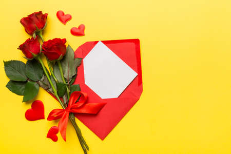 Valentine day composition with Envelope, rose flower and Red heart on table. Top view, flat lay....