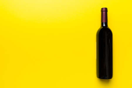 One Bottle of red wine on colored table. Flat lay, top view wth copy space.の写真素材