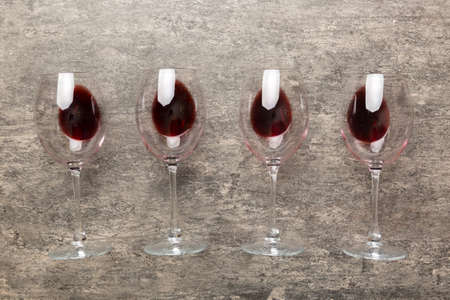 Many glasses of red wine at wine tasting. Concept of red wine on colored background. Top view, flat...