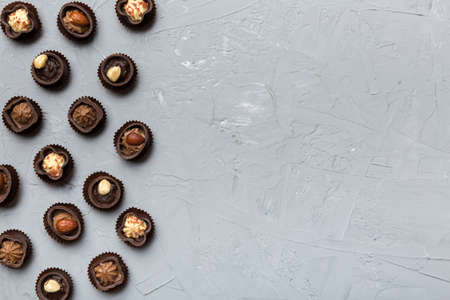 Different kinds of chocolates on colored table close-up. Top View and Flat Lay with copy space.