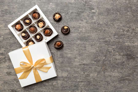 White box with chocolates candies and golden tape. top view with copy space.