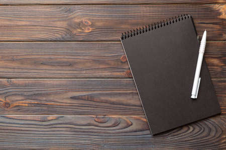 school notebook on a colored background, spiral black notepad on a table Top view.の写真素材
