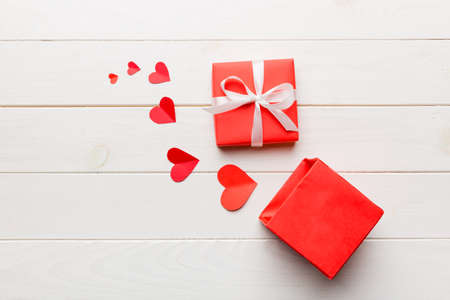 Happy valentines day opened heart shape gift box with small hearts, on colored background, valentines day card - top view concept.の写真素材