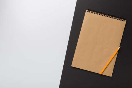 school brown notebook on a colored background, spiral craft notepad on a table Top view.の写真素材