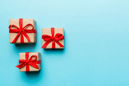 Valentine day composition: red gift box with bow and heart. Christmas present. View from above....
