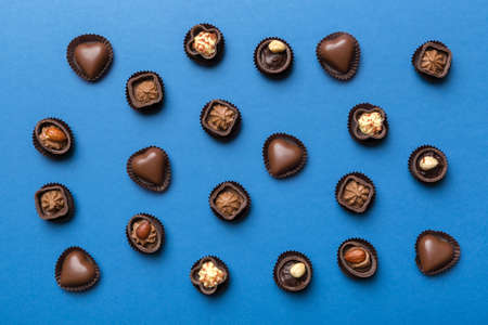 Different kinds of chocolates on colored table close-up. Top View and Flat Lay.