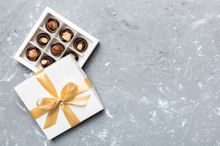 White box with chocolates candies and golden tape. top view with copy space.の写真素材
