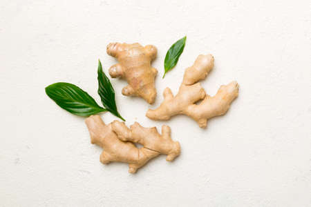 Finely dry Ginger powder in bowl with green leaves isolated on colored background. top view flat...