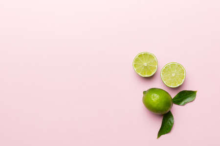 Lime fruits with green leaf and cut in half slice isolated on white background. top view. Flat lay...