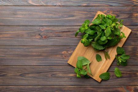 Fresh mint on Cutting board table, top view. Flat lay Space for text.の写真素材