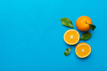 fresh Fruit orange slices on colored background. top view. copyspace. creative summer concept. Half of citrus in minimal flat lay with copy space.の写真素材