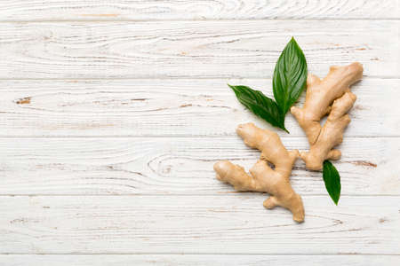 Finely dry Ginger powder in bowl with green leaves isolated on colored background. top view flat lay.の写真素材