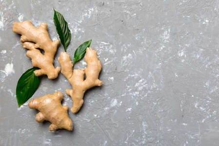 Finely dry Ginger powder in bowl with green leaves isolated on colored background. top view flat lay.の写真素材