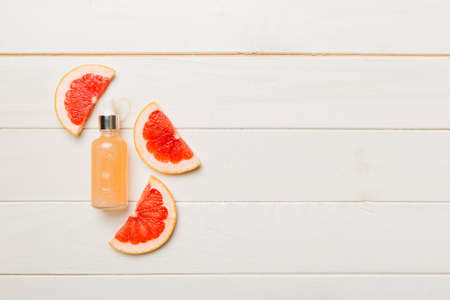 Bottles with lemon fruit essential oil on wooden background. alternative medicine top view with copy space.の写真素材