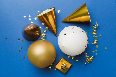 Holiday background with colorful balloon, gift and confetti. Flat lay style. Birthday or party greeting card with copy space.の写真素材