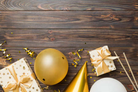 Holiday background with colorful balloon, gift and confetti. Flat lay style. Birthday or party greeting card with copy space.の写真素材