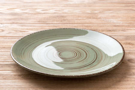 Perspective view of empty green plate on cement background. Empty space for your design.の写真素材