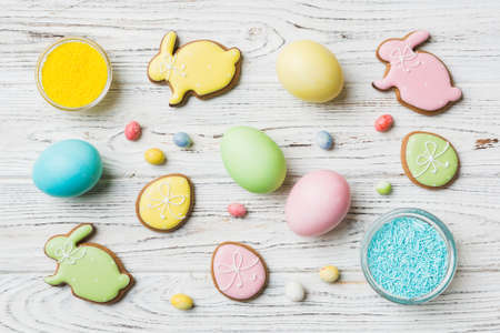 holiday preparation Multi colors Easter eggs with cookies on colored background . Pastel color Easter eggs. holiday concept with copy space.の写真素材