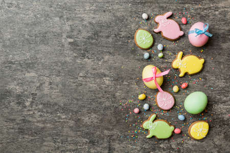 holiday preparation Multi colors Easter eggs with cookies on colored background . Pastel color Easter eggs. holiday concept with copy space.の写真素材