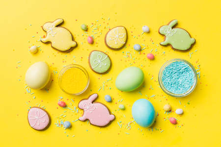 holiday preparation Multi colors Easter eggs with cookies on colored background . Pastel color Easter eggs. holiday concept with copy space.の写真素材
