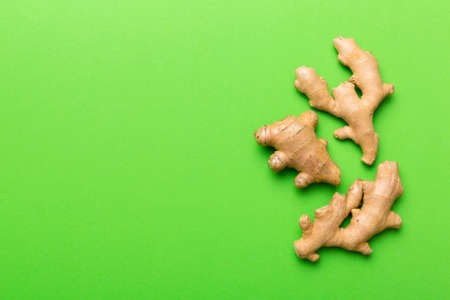 Finely dry Ginger powder in bowl with green leaves isolated on colored background. top view flat lay.の写真素材