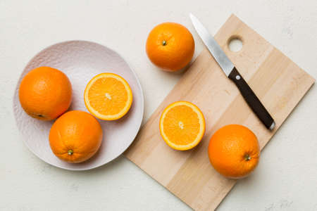 Fresh ripe oranges on cutting board on table. Top view flat lay.の写真素材