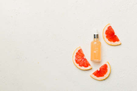 Bottles with Grapefruit fruit essential oil on wooden background. alternative medicine top view with copy space.の写真素材