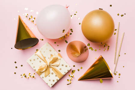 Holiday background with colorful balloon, gift and confetti. Flat lay style. Birthday or party greeting card with copy space.の写真素材