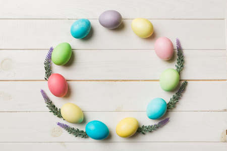 round frame Multi colors Easter eggs on colored background . Pastel color Easter eggs holiday concept with empty space for you design.の写真素材