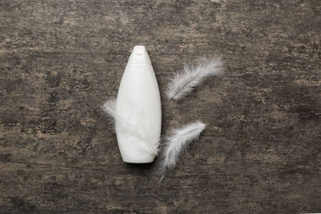 Spa cosmetic product, cream jar, branding mock up, top view with feathers background. flat lay.