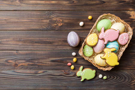Multi colors Easter eggs in the woven basket on colored background . Pastel color Easter eggs....