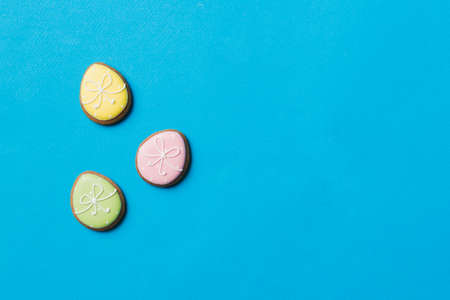 holiday preparation Multi colors Easter eggs with cookies on colored background . Pastel color Easter eggs. holiday concept with copy space.の写真素材