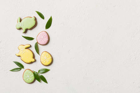 holiday preparation Multi colors Easter eggs with cookies on colored background . Pastel color Easter eggs. holiday concept with copy space.の写真素材