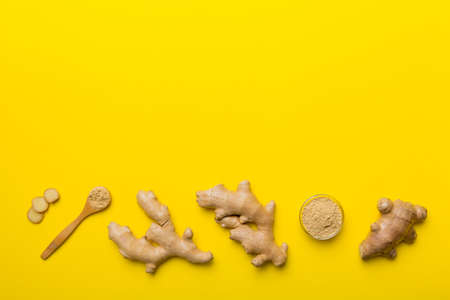 Finely dry Ginger powder in bowl with green leaves isolated on colored background. top view flat lay.の写真素材