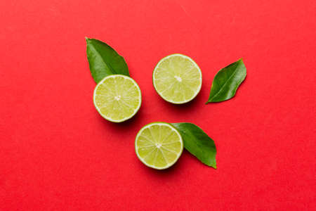 Lime fruits with green leaf and cut in half slice isolated on white background. top view. Flat lay...