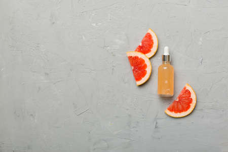 Bottles with Grapefruit fruit essential oil on wooden background. alternative medicine top view with copy space.の写真素材