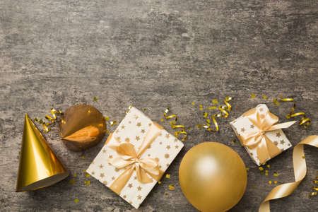 Holiday background with colorful balloon, gift and confetti. Flat lay style. Birthday or party...