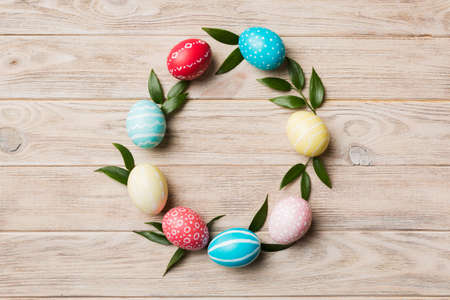 round frame Multi colors Easter eggs on colored background . Pastel color Easter eggs holiday...