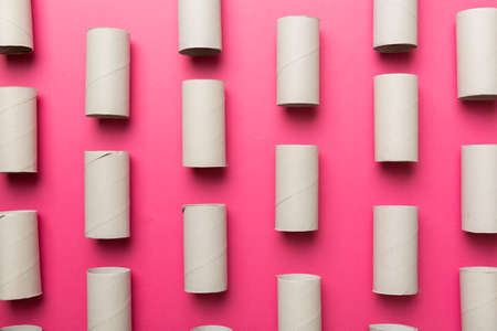 Empty toilet paper roll on colored background. Recyclable paper tube with metal plug end made of kraft paper or cardboard.の写真素材