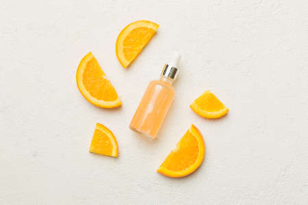 Bottles with orange fruit essential oil on wooden background. alternative medicine top view with copy space.の写真素材
