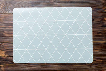 Top view of gray tablecloth for food on wooden background. Empty space for your design.