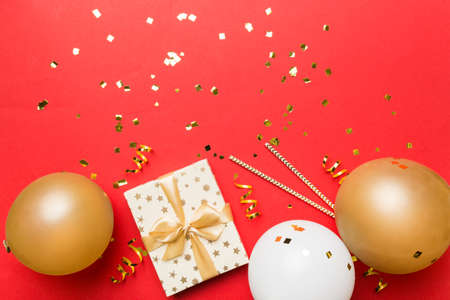Holiday background with colorful balloon, gift and confetti. Flat lay style. Birthday or party greeting card with copy space.の写真素材