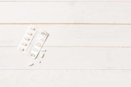 Protective face masks or surgical masks, medicine pills and thermometer on table background....